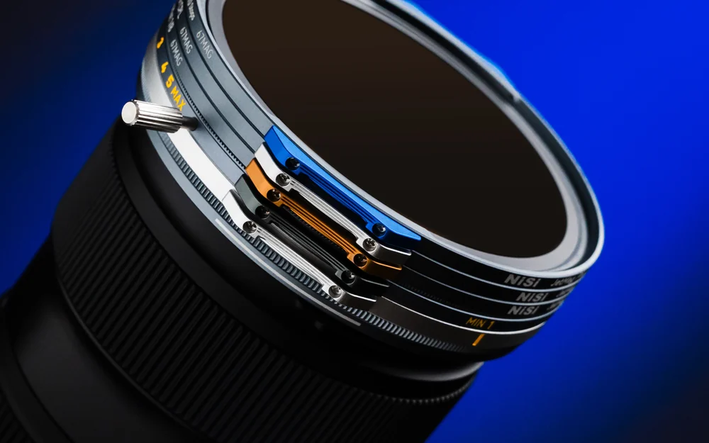 A stack of NiSi JetMag Pro 67MAG filters with colored handles on a lens
