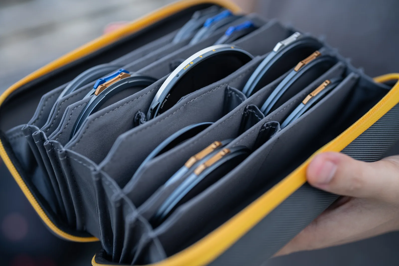 Close view of the microfiber-lined pockets inside a NiSi Caddy MAX, each holding one circular filter