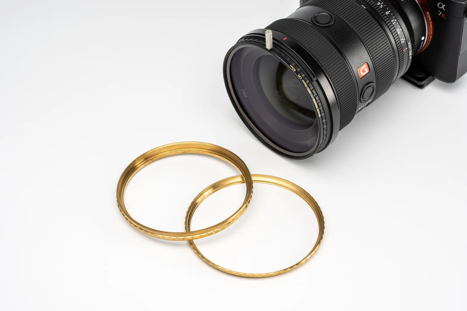 Two brass filter rings in front of a Sony camera with the CPL fitted