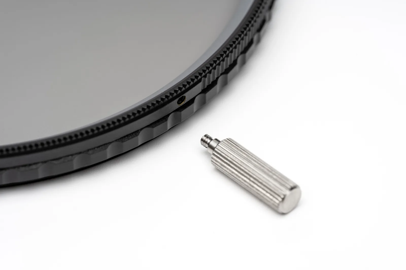 The removable adjustment knob lying beside the CPL frame