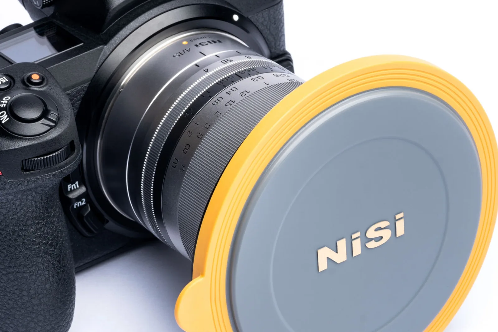 A Nikon mirrorless camera with a NiSi V7 lens cap fitted over the adapter ring on the lens
