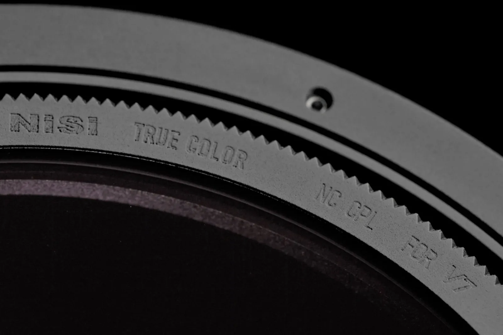 The geared edge of the NiSi True Color CPL for the V7 holder, lit against black